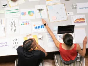 "Team reviewing a project management checklist on a whiteboard for efficient planning and execution."