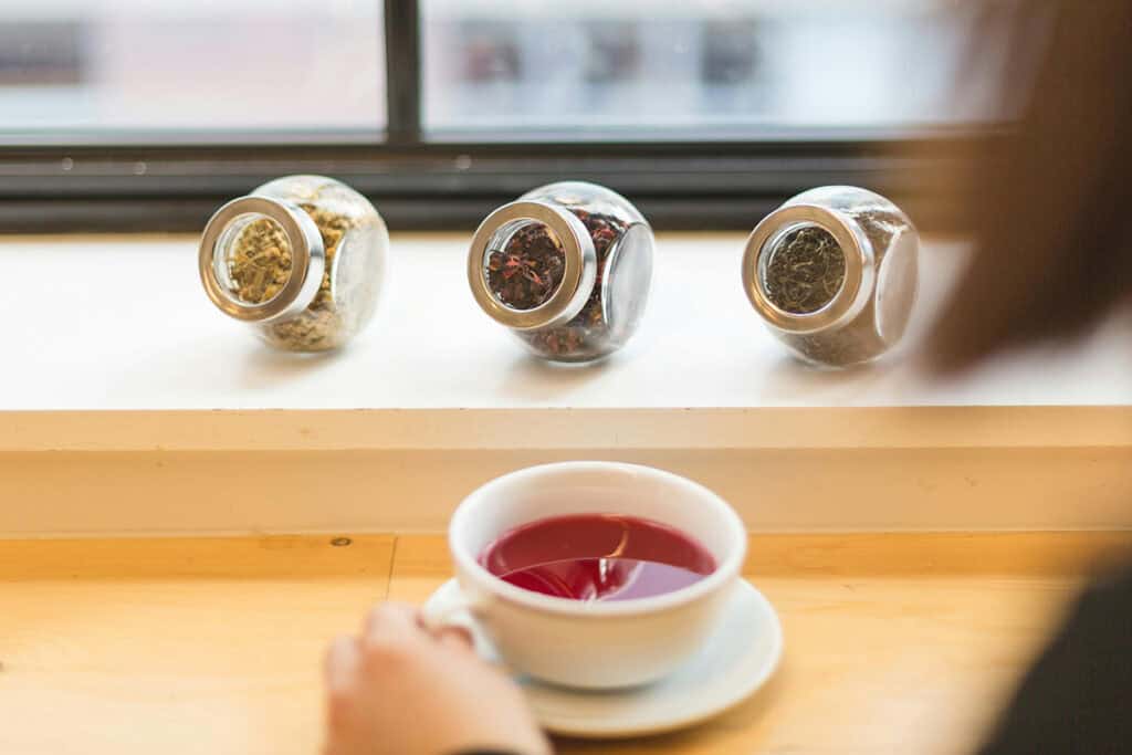 A selection of colorful wellness drinks placed on a wooden table, showcasing natural ingredients for a healthy lifestyle.